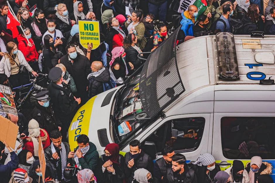 Protester Charged in Australia — Markets Watch Political Tensions